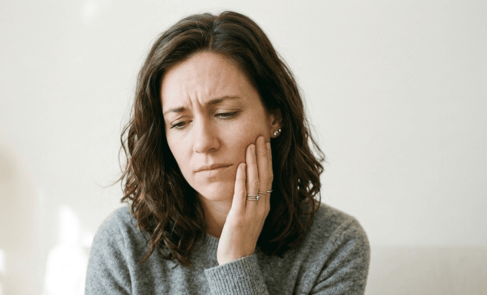 Woman experiencing stinging from moisturizer on sensitive skin